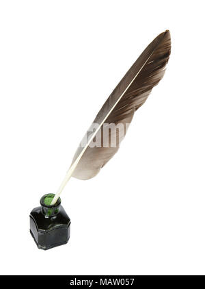 Dark feather in the green glass inkwell isolated on a white background Stock Photo