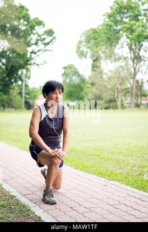 Senior woman exercising in park Stock Photo