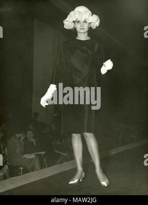 Model from the sixties walking on the catwalk, Italy Stock Photo
