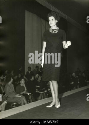 Model from the sixties walking on the catwalk, Italy Stock Photo