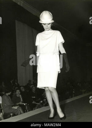 Model from the sixties walking on the catwalk, Italy Stock Photo