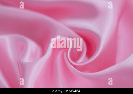Abstract background of luxury pink wrinkled silk cloth, liquid waves, wavy folds for background texture. Stock Photo