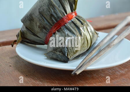 sticky rice steam with pork and salt egg in banana leaf of Chinese Duanwu festival Stock Photo