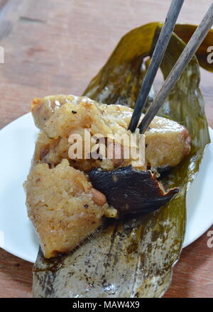 sticky rice steam with pork and salt egg in banana leaf of Chinese Duanwu festival Stock Photo