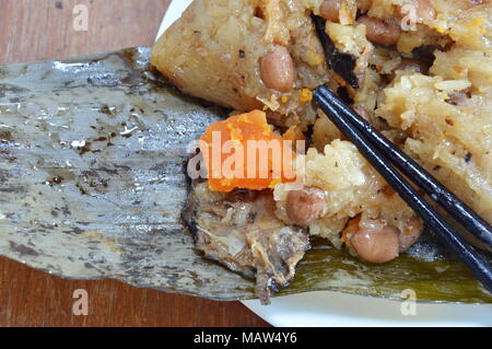 sticky rice steam with pork and salt egg in banana leaf of Chinese Duanwu festival Stock Photo