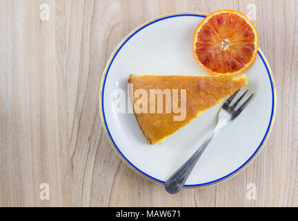 Cake, orange cake with orange slide in white plate on wood table background, Top view with copy space. Stock Photo