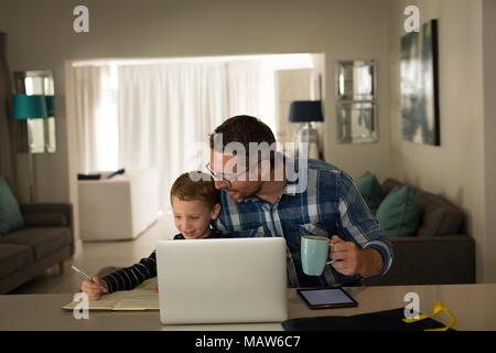 Father helping son with his homework Stock Photo