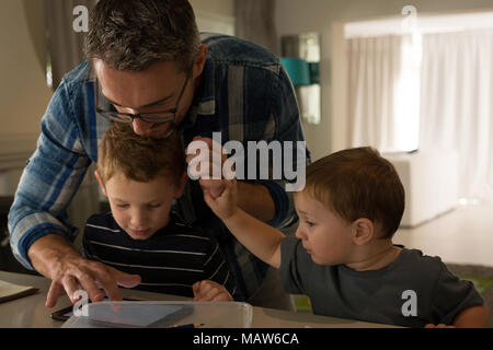 Father and his sons using digital tablet Stock Photo