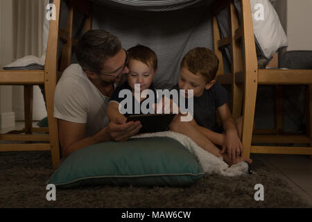Father with his sons using digital tablet Stock Photo