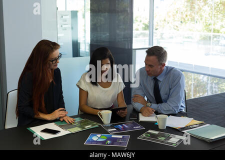 Business colleagues working on digital tablet Stock Photo