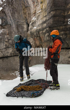 Male rock climber wearing harness near rocky mountain Stock Photo