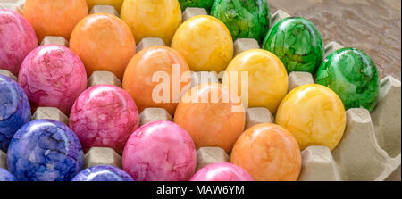 Cardboard box with colored easter eggs Stock Photo