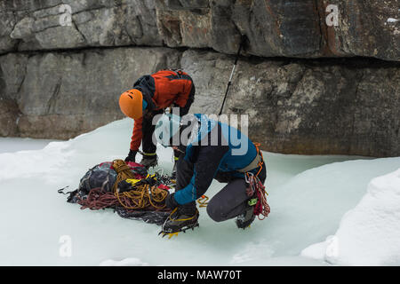 Male rock climber wearing crampons near rocky mountain Stock Photo