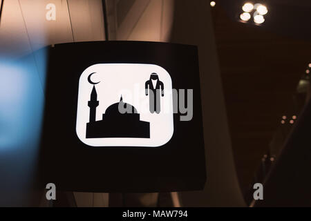 Mens prayer room sign on airport wit blue lights around Stock Photo