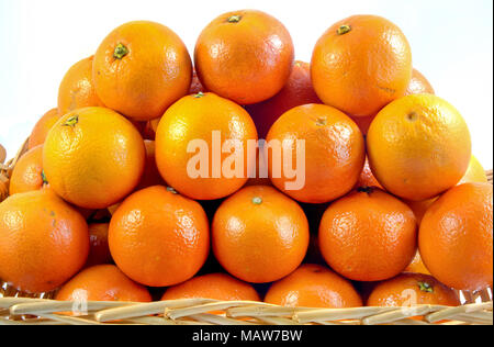 Fresh orange, organic ripe mandarins, pile of orange in wood basket on white background with clipping path. Stock Photo