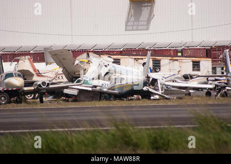 San Juan, Puerto Rico. 25th October, 2017. Planes destroyed by Hurricane Maria are piled next to the runway at San Juan airport in Puerto Rico one month after Hurricane Maria devastated the island. Credit: Sara Armas/Alamy Reportage. Stock Photo