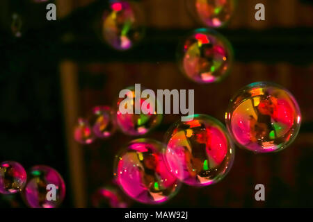 Abstract image of soap bubbles from the bubble blower in dark. Stock Photo