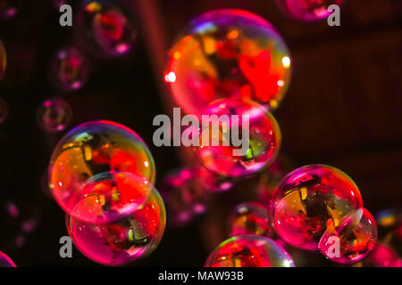 Abstract image of soap bubbles from the bubble blower in dark. Stock Photo