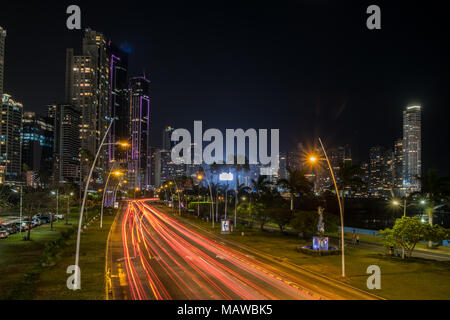 city at night, street traffic with modern skyscraper skyline - Stock Photo