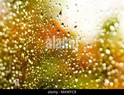 Raindrops at a window glass. Selective focus or closeup shot of rain drops on a window. Stock Photo