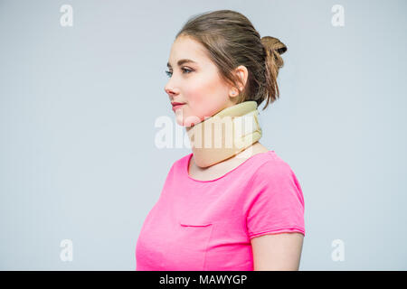 Portrait of young woman with a neck injury, osteochondrosis collar to prevent and physiotherapy. Pain treatment. Neurology, Osteopathy, chiropractic.  Stock Photo