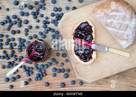 Homemade Blueberry jam and bread on a wood background Stock Photo