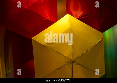 Bright retail display window using bright colours to attract passersby to the Spring collection, UK Stock Photo