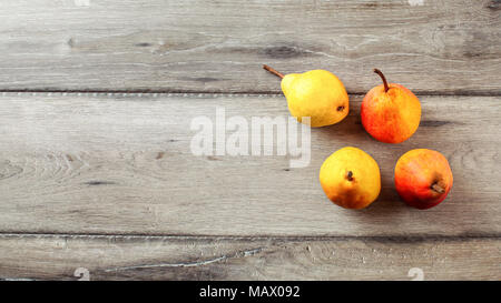 Top view of ripe pears, on gray wooden table. Stock Photo
