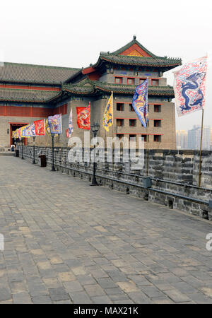 View of the Southeastern Tower of the city walls at the Ming Dynasty City Wall Relics park, Beijing, China, with replica Ming dynasty flags Stock Photo