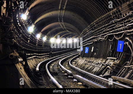 Architecture of the railway tracks leading into the tunnel. Urban city railroad environment. Stock Photo