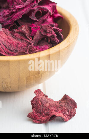 Dried beetroot chips on white table. Stock Photo