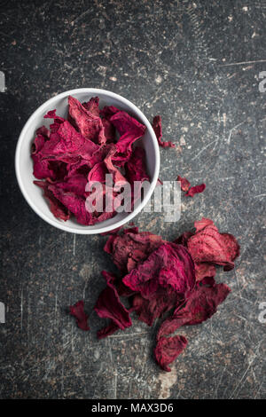 Dried beetroot chips in bowl. Stock Photo