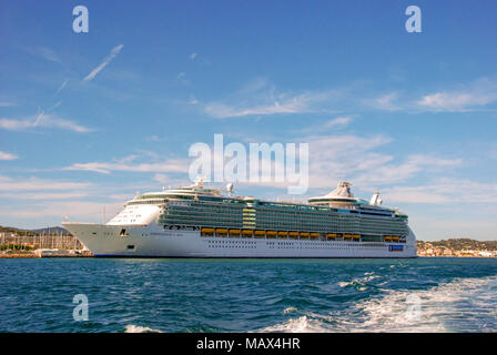 Wide angle view of the cruise liner Independence of the Seas with the wake of a fast ferry in the foreground Stock Photo