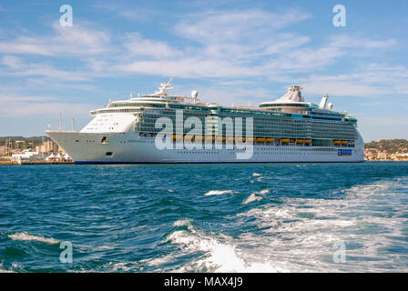 Wide angle view of the cruise liner Independence of the Seas with the wake of a fast ferry in the foreground Stock Photo