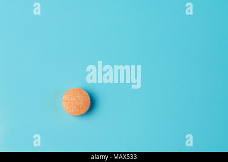 Tablet vitamin c on a blue surface Stock Photo