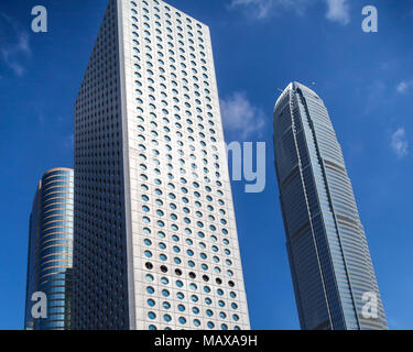 Jardine House with its round windows stands next to Two International Finance Centre in the Central district of Hong Kong. Stock Photo