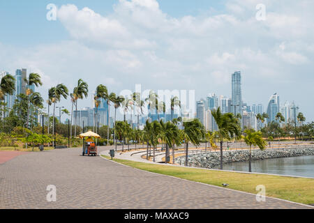 Sidewalk at public park with city skyline at coast promenade in Panama City Stock Photo