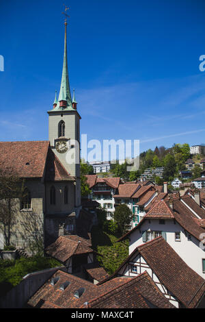View of Holy Spirit Church (Heiliggeistkirche) with rooftops of houses in Bern Switzerland Stock Photo