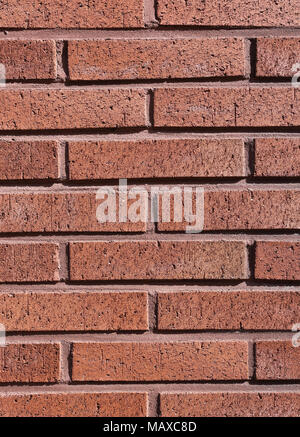 A closeup of a red / orange brick wall that's very clean and symmetric. Perfect background or wallpaper. Stock Photo