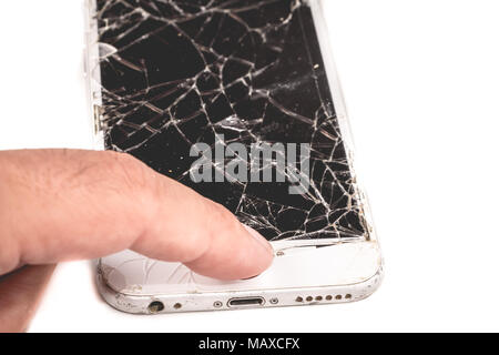 Paris, FRANCE - August 26, 2017: A man holds in his hand an iphone 6S of Apple Inc. whose screen is broken as a result of a violent fall Stock Photo