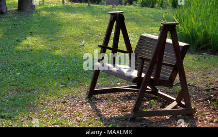 relaxing home garden with a wooden bench Stock Photo