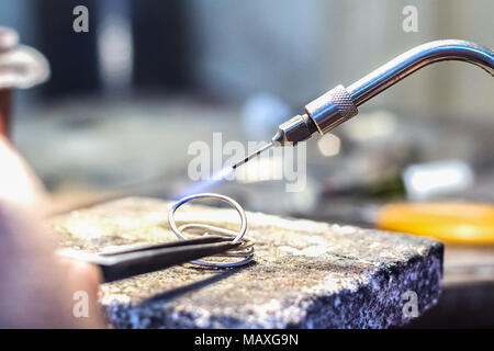 Jeweler welding a silver piece with a mini gas - oxygen torch welder Stock  Photo - Alamy