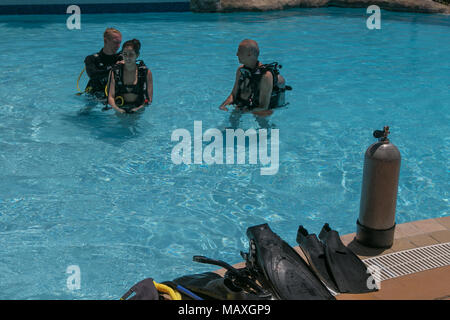 Bridgetown, Barbados, March 19, 2018: People are taking initial SCUBA lessons in a hotel pool. Stock Photo