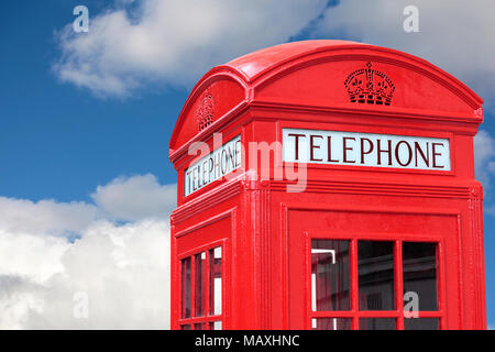 London traditional red telephone box isolated against a blue cloudy sky Stock Photo