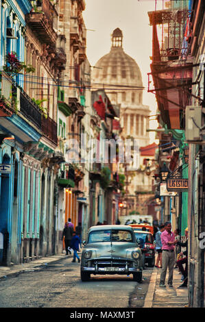 typical vintage view of a street of old havana, cuba with peoples and old cars Stock Photo