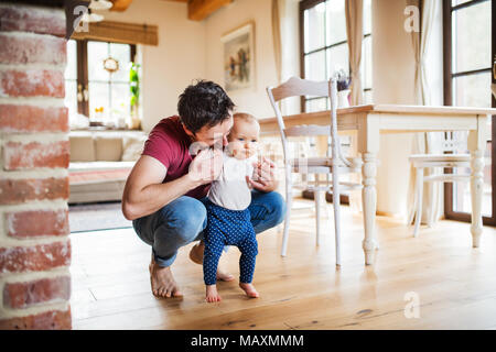 Father with a baby girl at home. Stock Photo