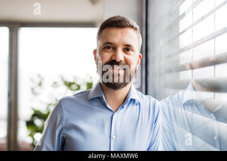 A man by the window at home. Stock Photo