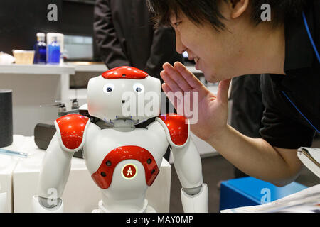 Tokyo, Japan. April 5, 2018. A man interacts with a robot during the 2nd AI Expo at Tokyo Big Sight on April 5, 2018, Tokyo, Japan. The trade show introduces new technologies in robotics including AI (Artificial Intelligence) and AR (Augmented Reality) and runs from April 4 to 6. Credit: Rodrigo Reyes Marin/AFLO/Ģ����ý Live News Stock Photo