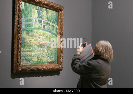 London UK. 5th April 2018. Giverny Lilly Pond. The First Monet exhibition in 20 years is staged at the National Gallery  featuring works by French Impressionist  Claude Monet spanning his long carreer with paintings from Venice , London, Rouen,The Monuments and Mysterious  II, The City and Modern and Village and Picturesque Credit: amer ghazzal/Alamy Live News Stock Photo