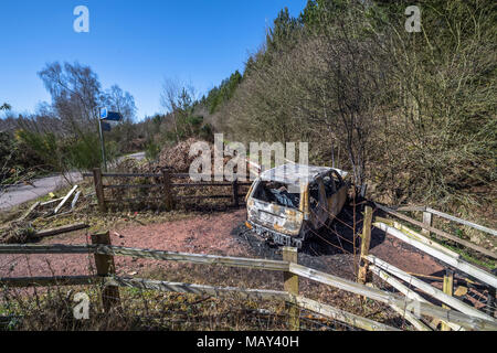 Sherwood Forest, Nottinghamshire, England, UK. 5th. April, 2018.  Burnt out vehicle blocking a woodland path on a warm and sunny Spring day.Alan Beastall/ Alamy Live News. Stock Photo